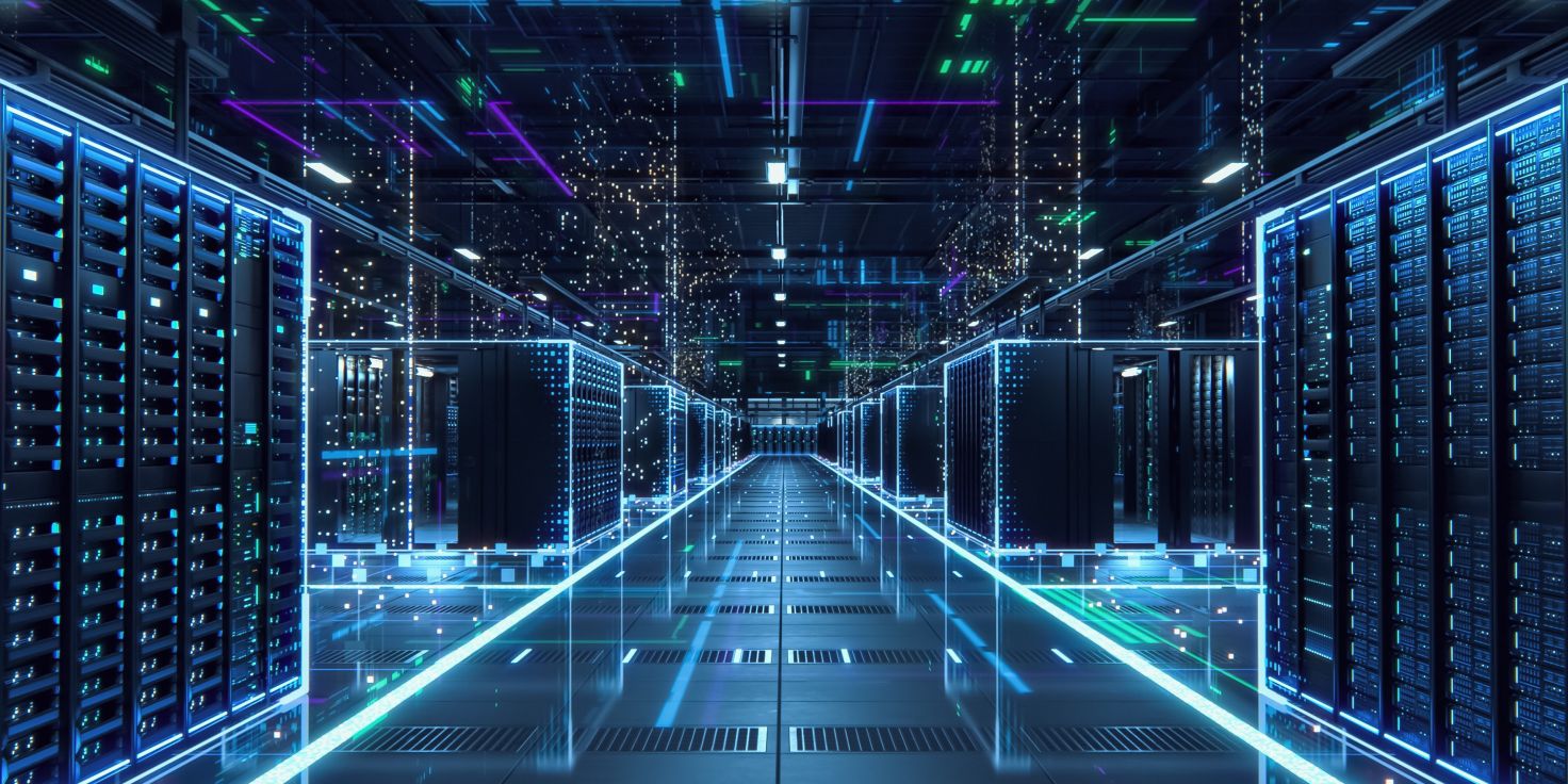 Rows of illuminated server racks inside a modern data center